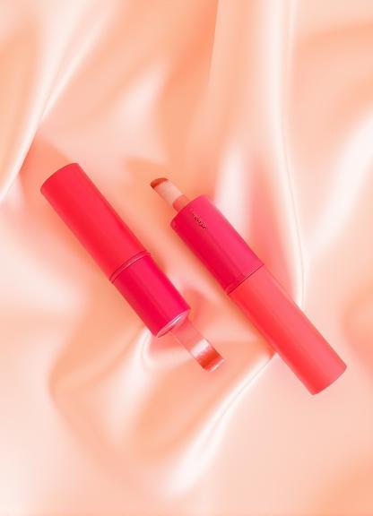 Blooming Lip Tint tubes uncapped on silk